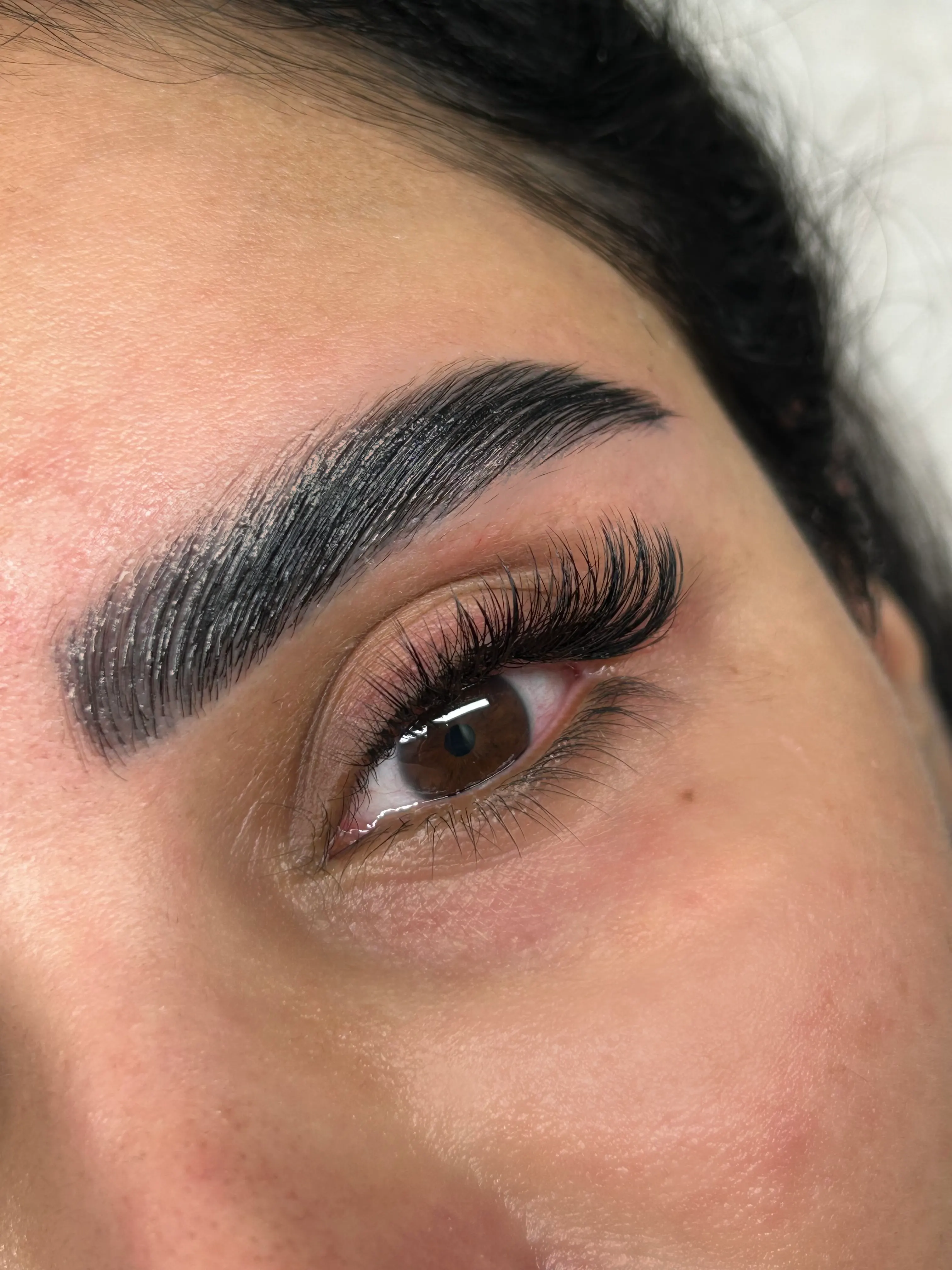 Close-up of hand-applied lash extensions finished at Azizam